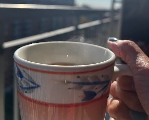 woman's hand holding a cup of tea